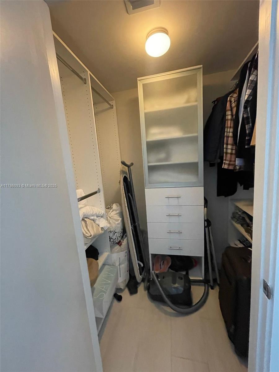 201 Southwest 17th Road, Unit 607 Miami, FL 33129 - Photo 14 of 31 a view of walk in closet with clothes and shoes