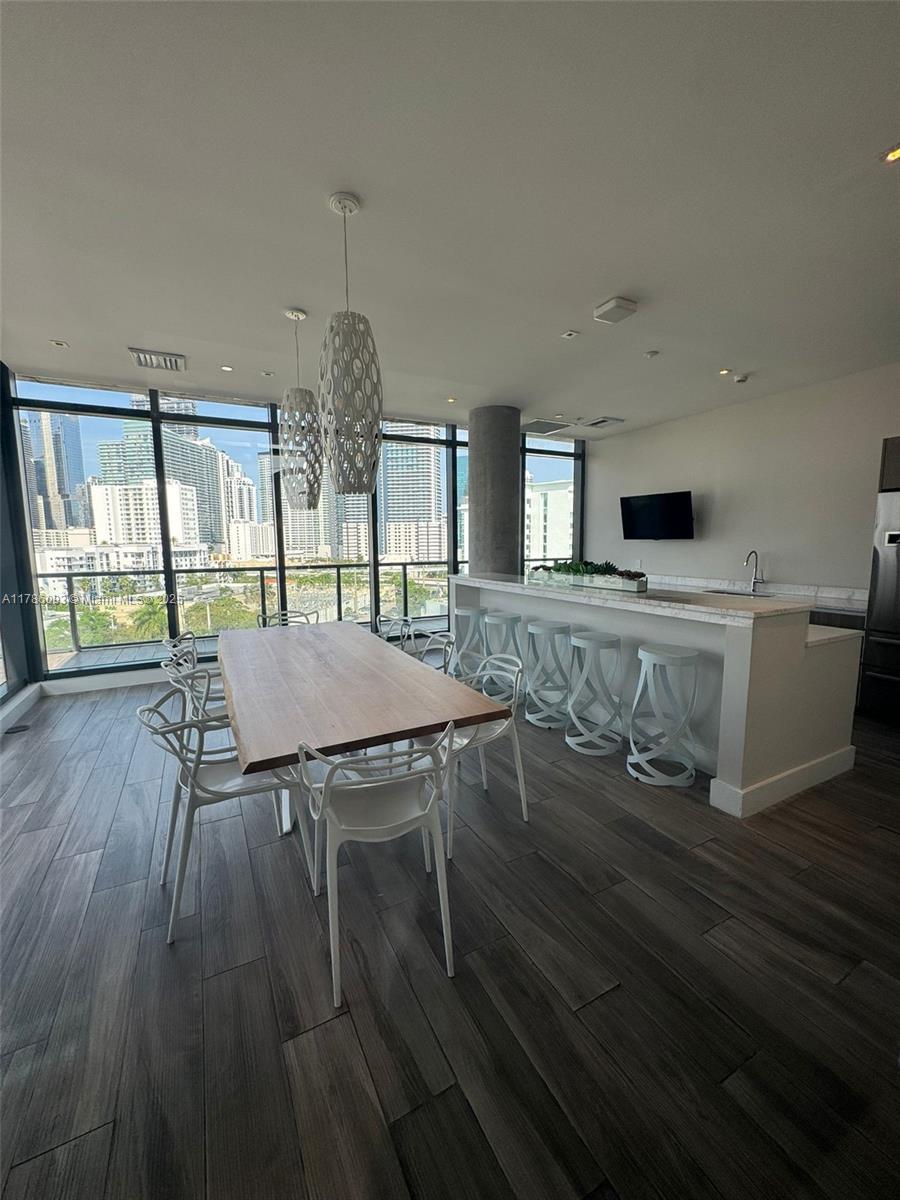 201 Southwest 17th Road, Unit 607 Miami, FL 33129 - Photo 29 of 31 a view of a dining room with furniture window and wooden floor