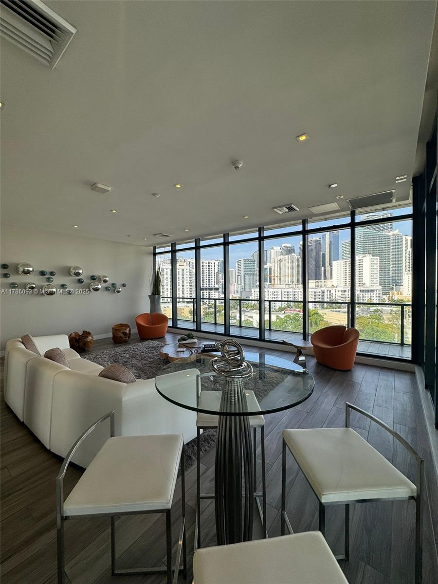 201 Southwest 17th Road, Unit 607 Miami, FL 33129 - Photo 30 of 31 a living room with furniture a large window and wooden floor