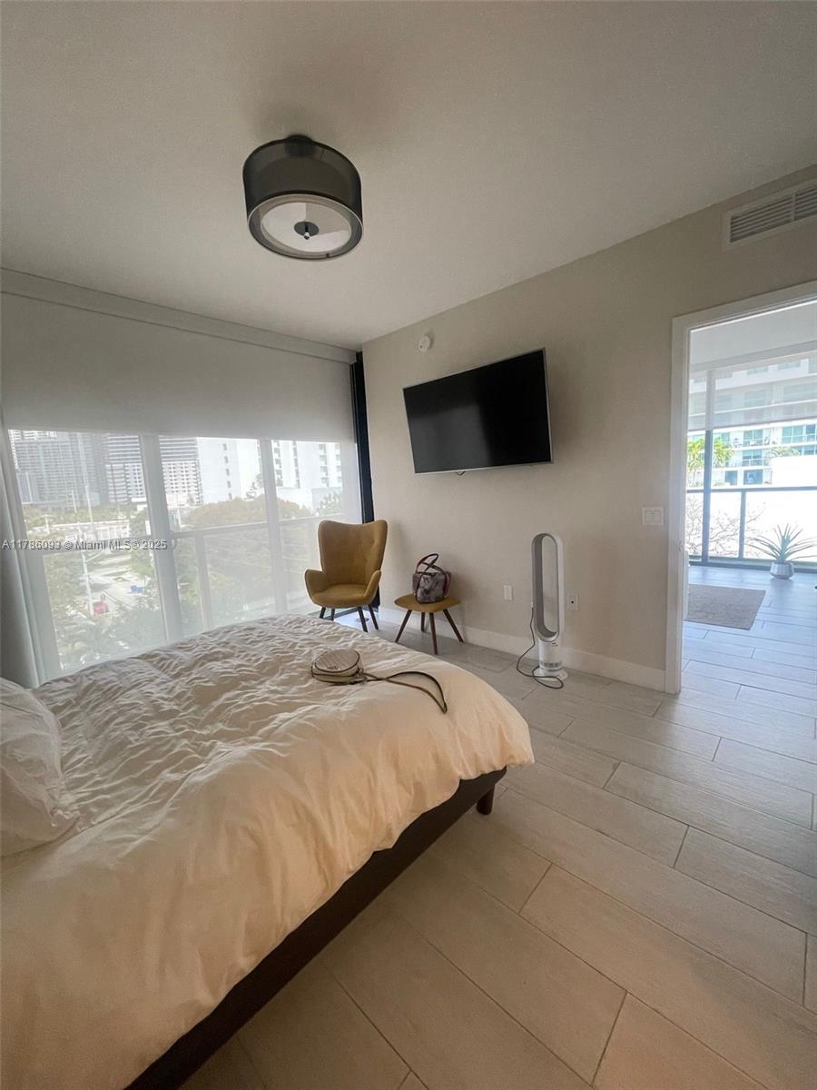 201 Southwest 17th Road, Unit 607 Miami, FL 33129 - Photo 6 of 31 a bedroom with a bed and flat screen tv