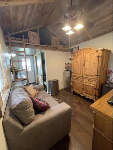 a living room with furniture and a mirror