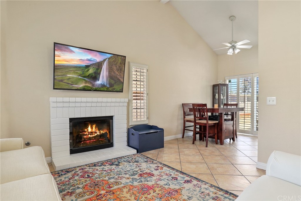 27002 Lightfoot Drive Corona, CA 92883 - Photo 11 of 31 a living room with furniture a flat screen tv and a fireplace