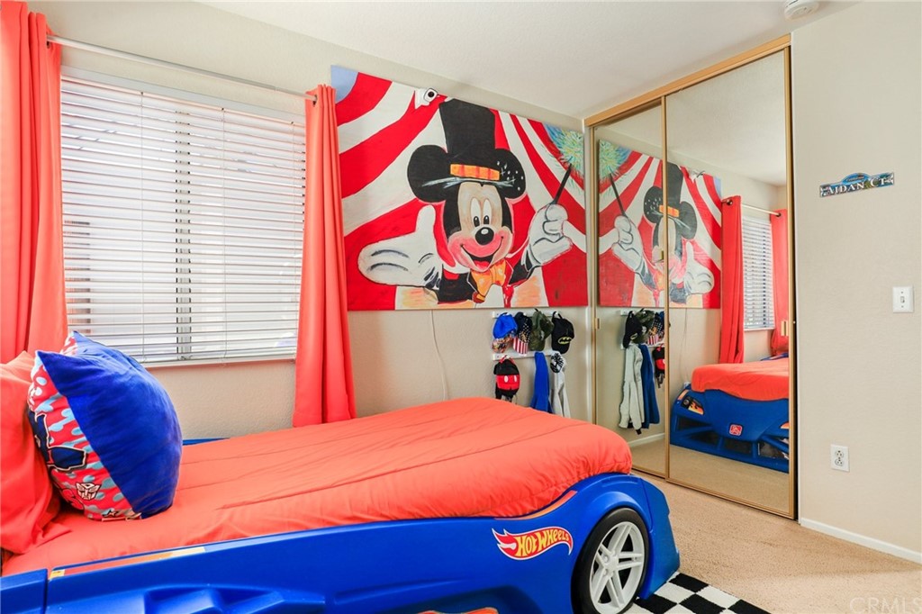 27002 Lightfoot Drive Corona, CA 92883 - Photo 14 of 31 a bedroom with a bed and a painting on the wall