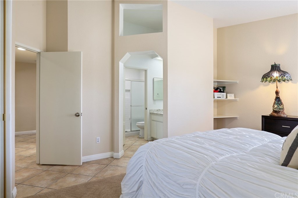 27002 Lightfoot Drive Corona, CA 92883 - Photo 16 of 31 a bedroom with a bed and a mirror