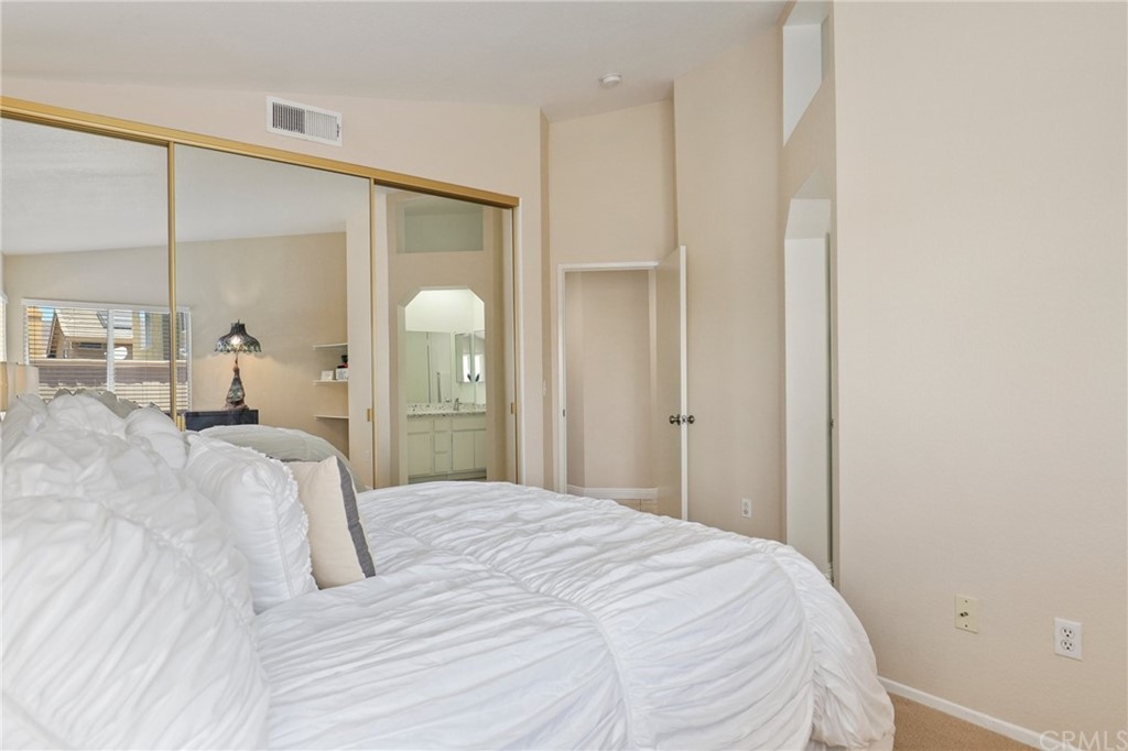 27002 Lightfoot Drive Corona, CA 92883 - Photo 17 of 31 a bedroom with a bed and a mirror