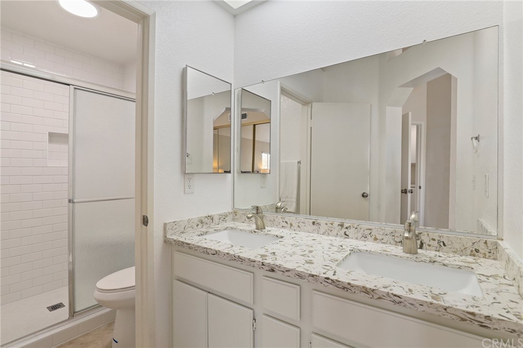 27002 Lightfoot Drive Corona, CA 92883 - Photo 18 of 31 a bathroom with a sink and a mirror