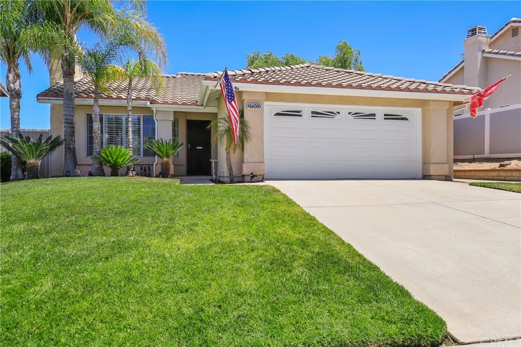 27002 Lightfoot Drive Corona, CA 92883 - Photo 2 of 31 a front view of a house with a garden and yard