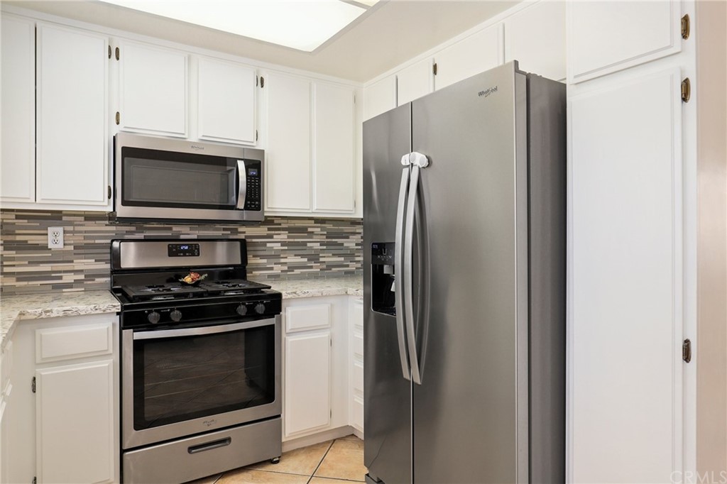 27002 Lightfoot Drive Corona, CA 92883 - Photo 5 of 31 a kitchen with stainless steel appliances a refrigerator stove and microwave