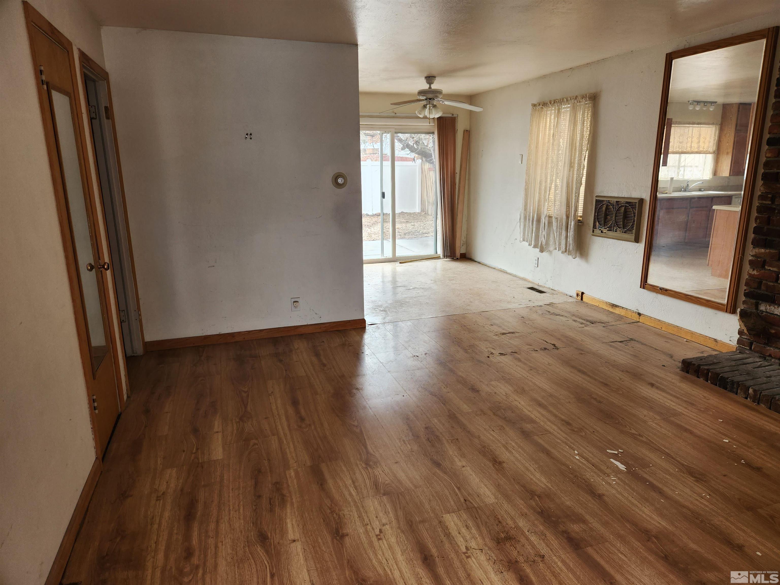 1610 West 7th Street Reno, NV 89503 - Photo 4 of 14 a view of an empty room with wooden floor and a window