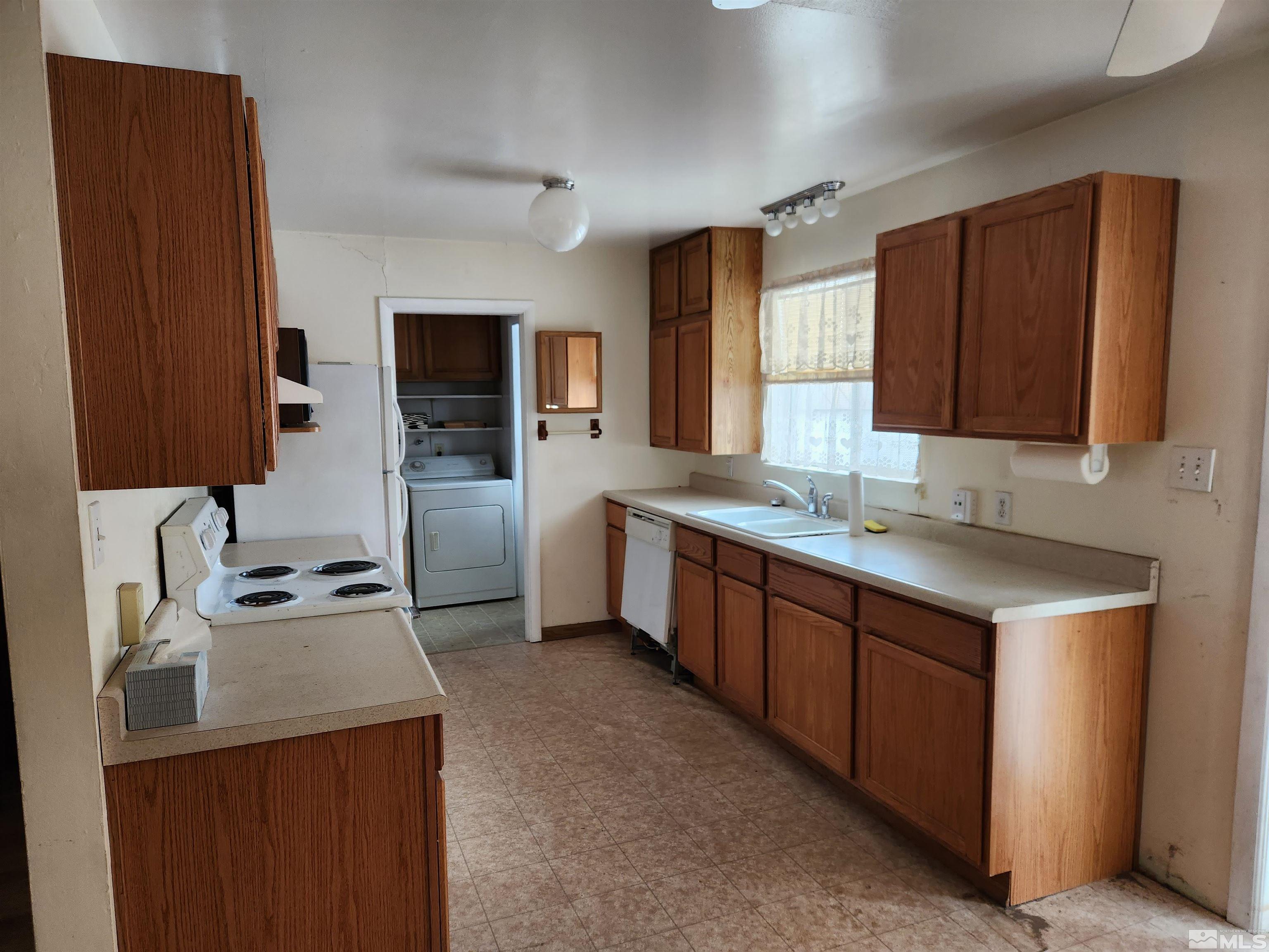 1610 West 7th Street Reno, NV 89503 - Photo 6 of 14 a kitchen with a sink stove top oven and cabinets