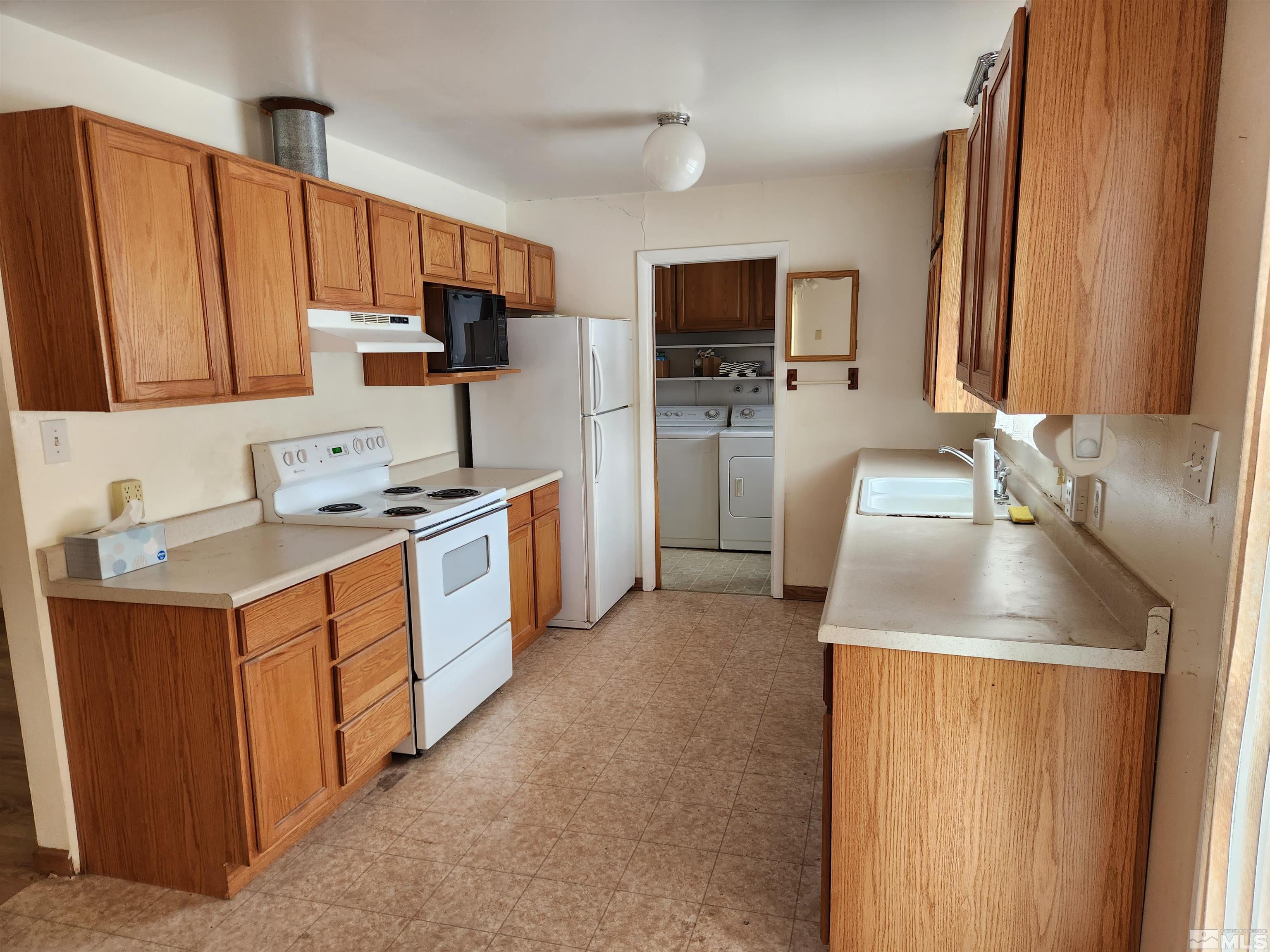 1610 West 7th Street Reno, NV 89503 - Photo 7 of 14 a kitchen with stainless steel appliances granite countertop a sink stove and refrigerator