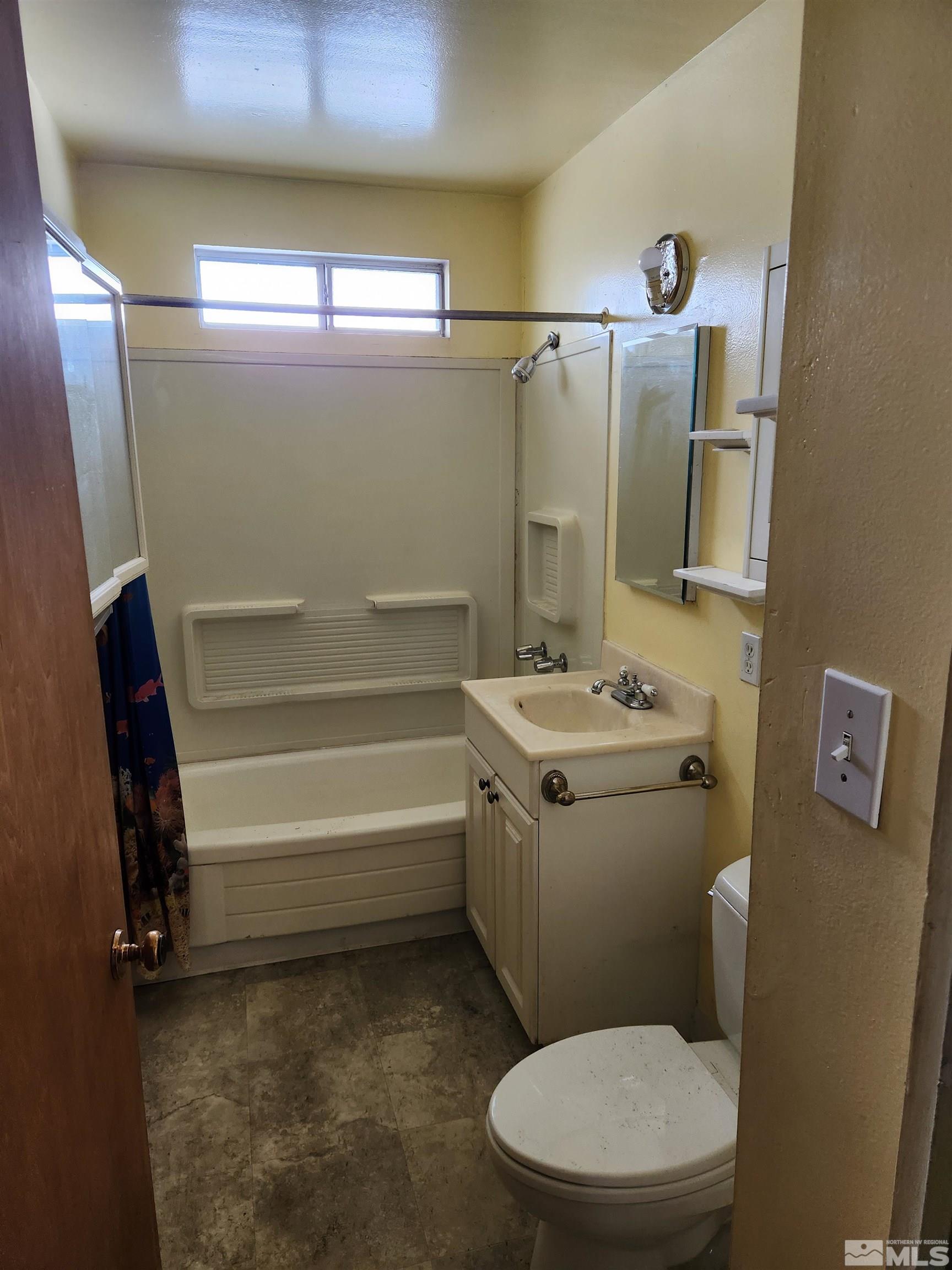 1610 West 7th Street Reno, NV 89503 - Photo 9 of 14 a bathroom with a sink a toilet and shower
