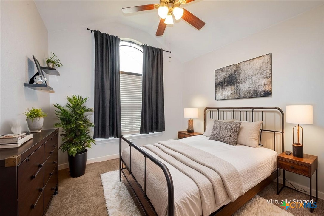 124 Prairie Circle Kempner, TX 76539 - Photo 13 of 34 a bedroom with bed and a chandelier