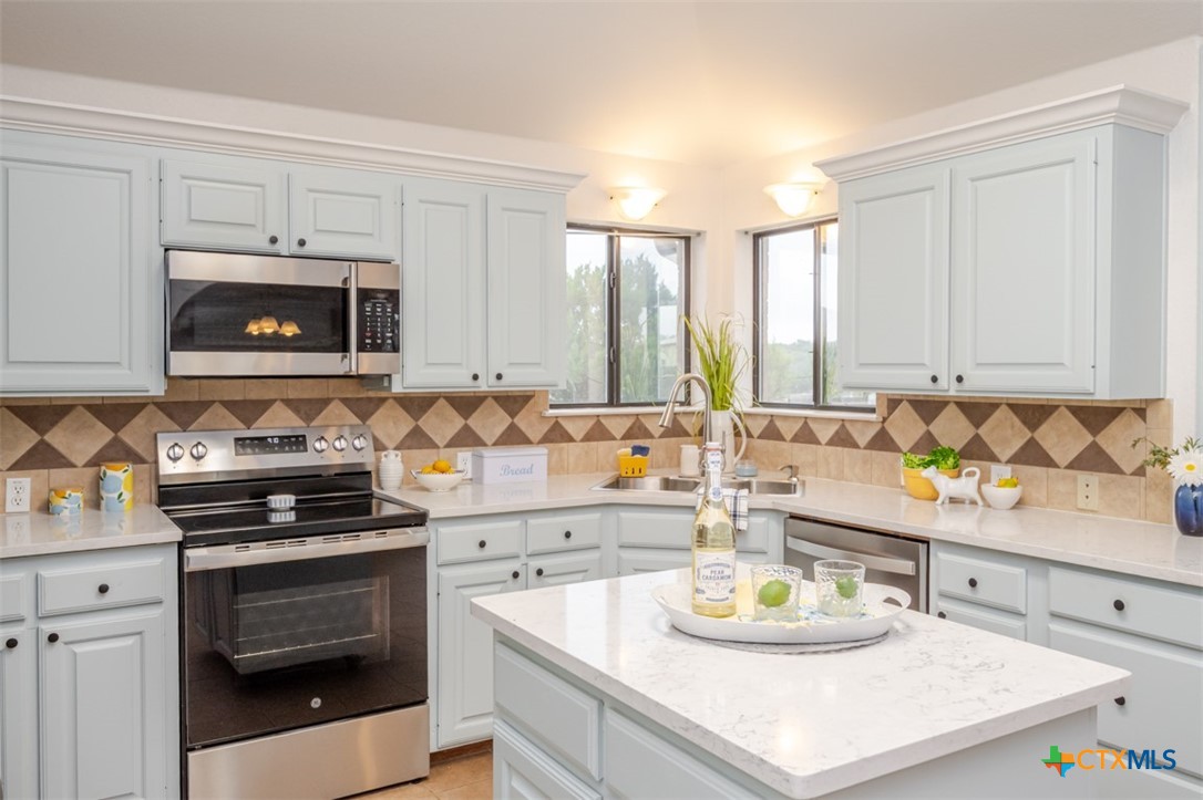 124 Prairie Circle Kempner, TX 76539 - Photo 4 of 34 a kitchen with sink a stove and cabinets