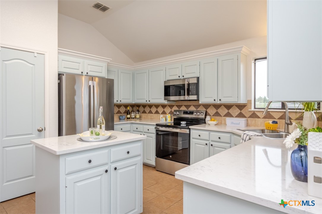 124 Prairie Circle Kempner, TX 76539 - Photo 5 of 34 a kitchen with a sink stove top oven and refrigerator