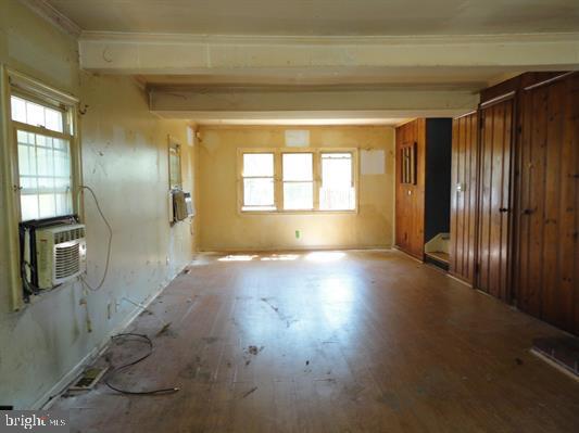 28 Main Street Bridgeton, NJ 08302 - Photo 2 of 29 an empty room with wooden floor and windows