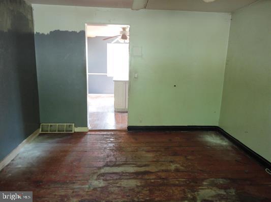 28 Main Street Bridgeton, NJ 08302 - Photo 8 of 29 an empty room with wooden floor and windows