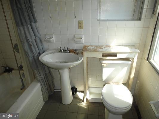 28 Main Street Bridgeton, NJ 08302 - Photo 10 of 29 a bathroom with a toilet sink and mirror