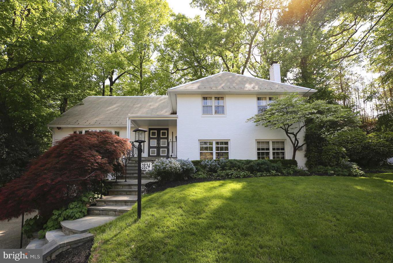 2824 Ellicott Street Northwest Washington, DC 20008 - Photo 1 of 47 a front view of a house with a yard