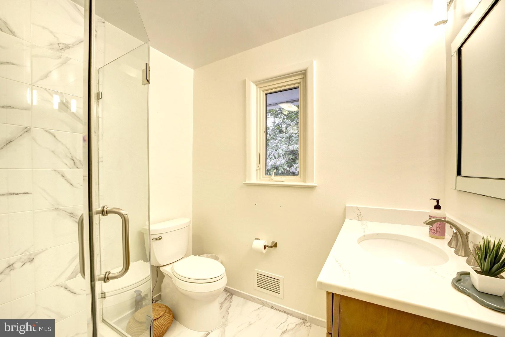2824 Ellicott Street Northwest Washington, DC 20008 - Photo 35 of 47 a bathroom with a sink toilet and shower