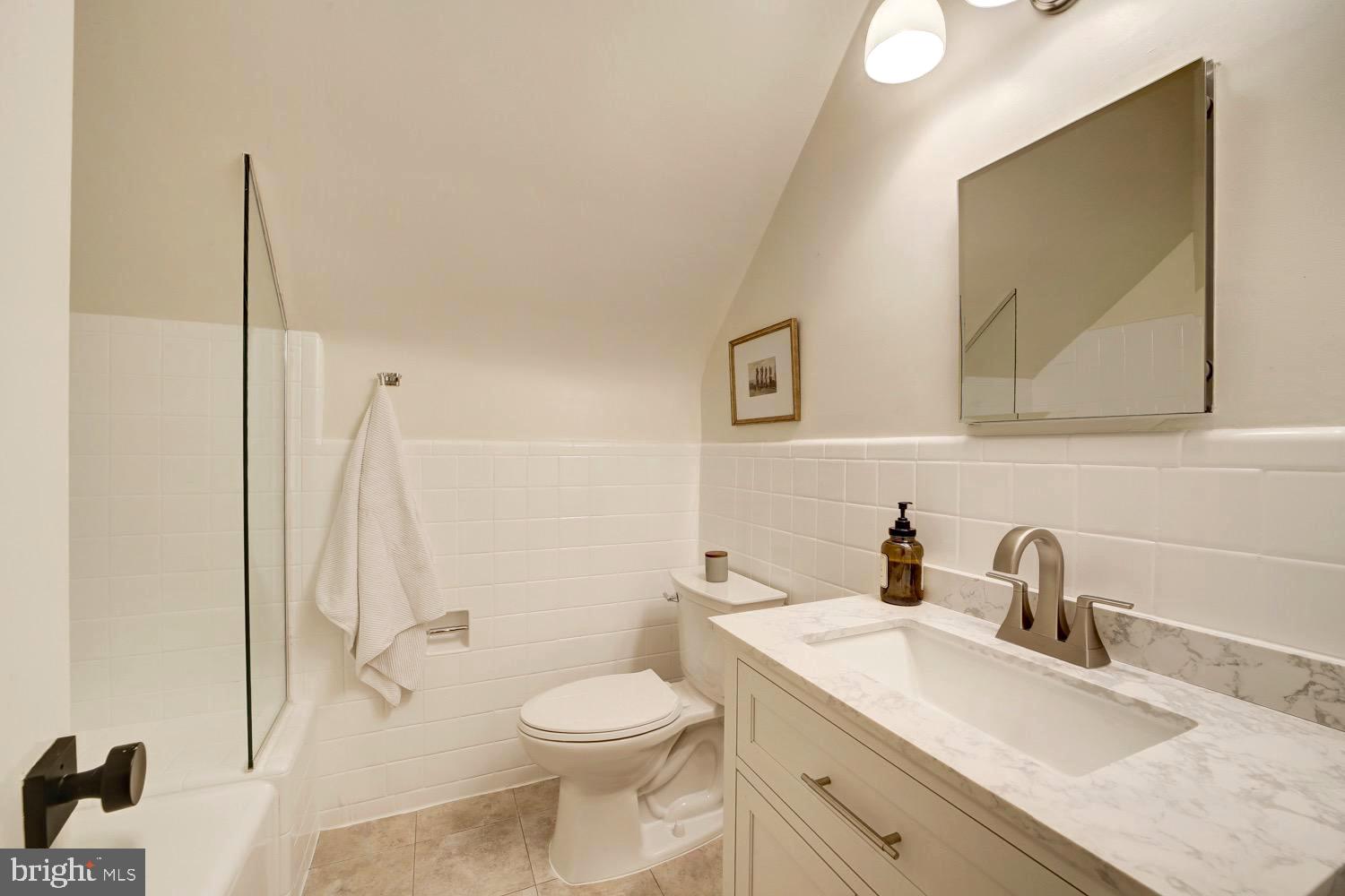 2824 Ellicott Street Northwest Washington, DC 20008 - Photo 42 of 47 a bathroom with a granite countertop sink mirror vanity and toilet