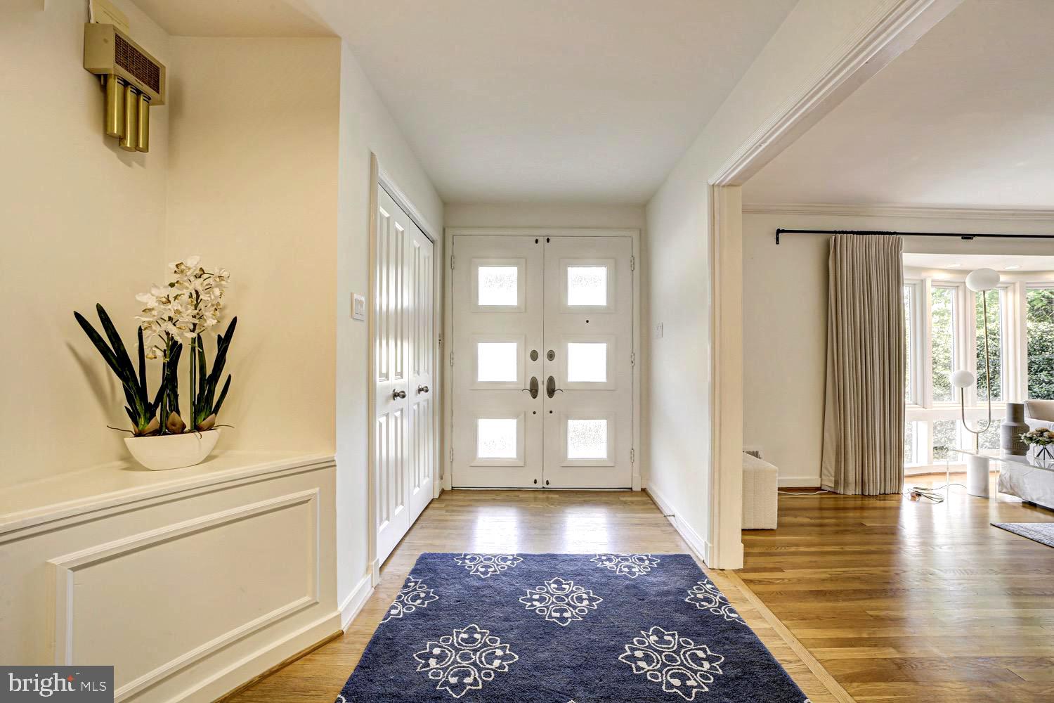 2824 Ellicott Street Northwest Washington, DC 20008 - Photo 5 of 47 a view of a hallway with wooden floor and a bathroom