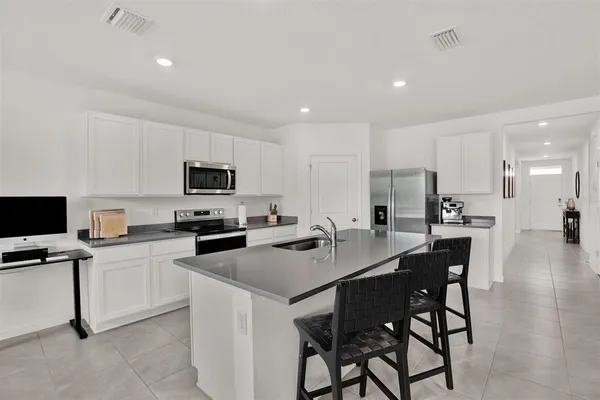 a kitchen with stainless steel appliances a sink stove and refrigerator