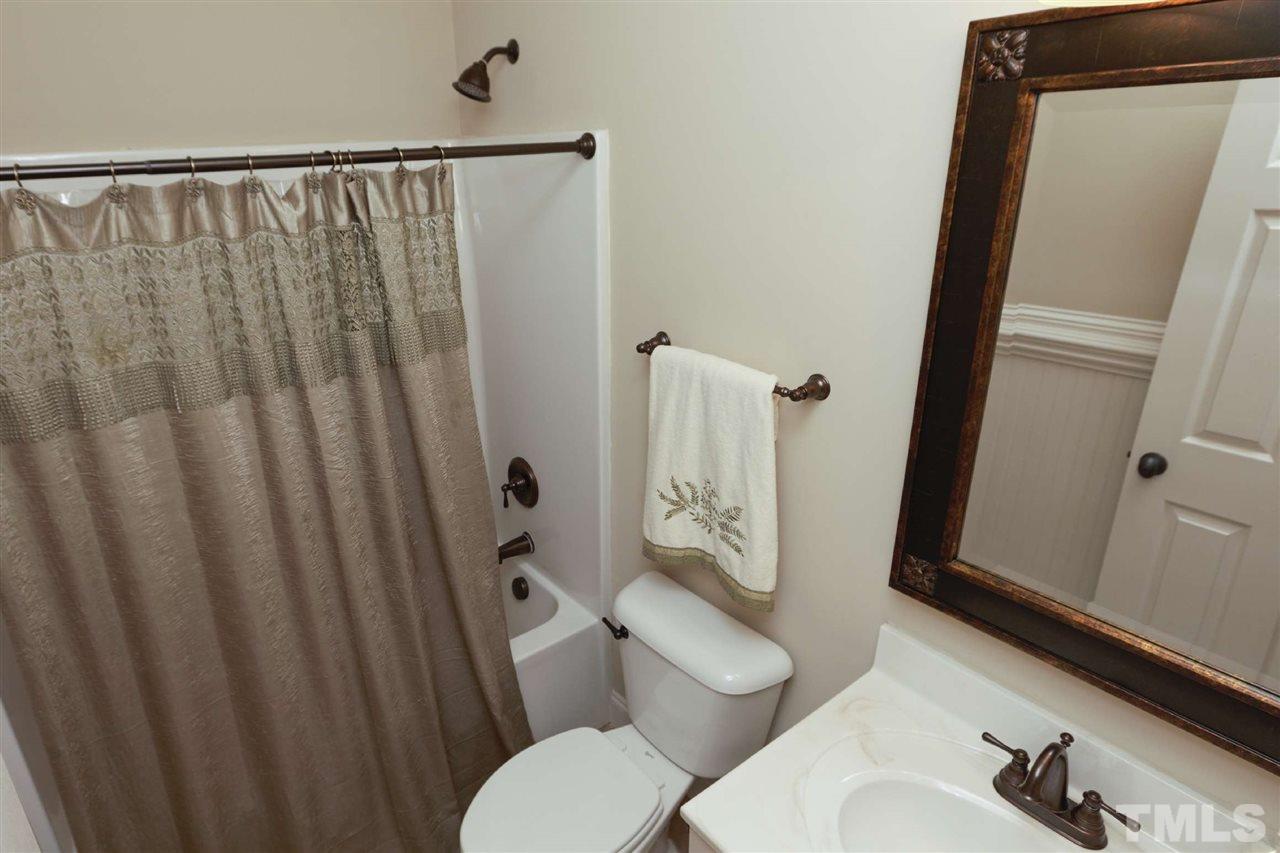 5804 Turner Store Lane Raleigh, NC 27603 - Photo 14 of 25 a white toilet sitting next to a bathroom sink