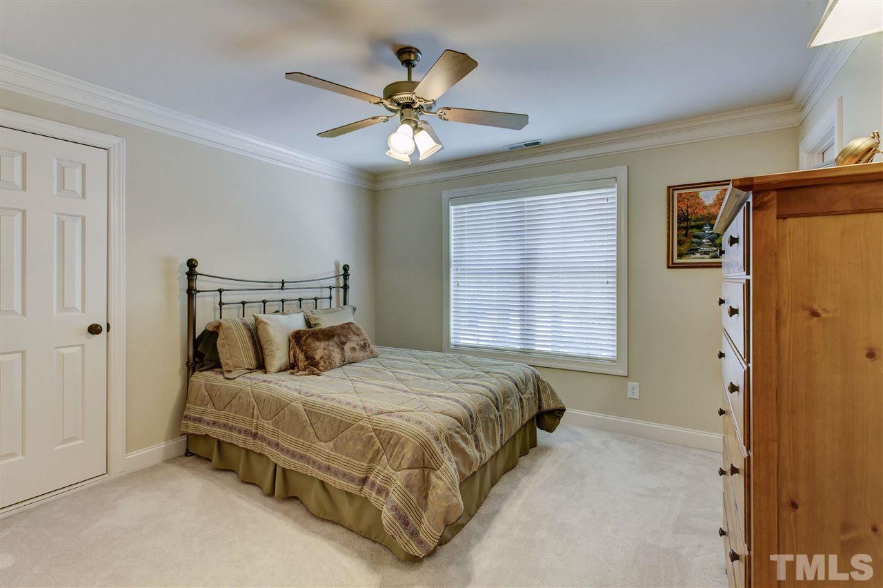 5804 Turner Store Lane Raleigh, NC 27603 - Photo 18 of 25 a bedroom with a bed and window