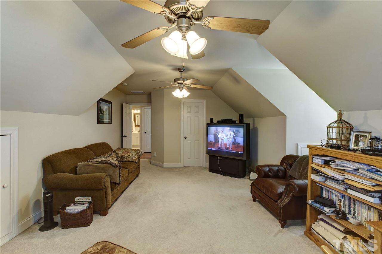 5804 Turner Store Lane Raleigh, NC 27603 - Photo 21 of 25 a living room with furniture and a chandelier