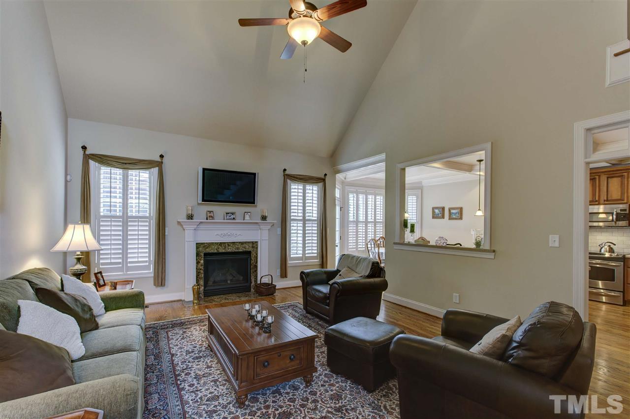 5804 Turner Store Lane Raleigh, NC 27603 - Photo 4 of 25 a living room with furniture a fireplace and a flat screen tv