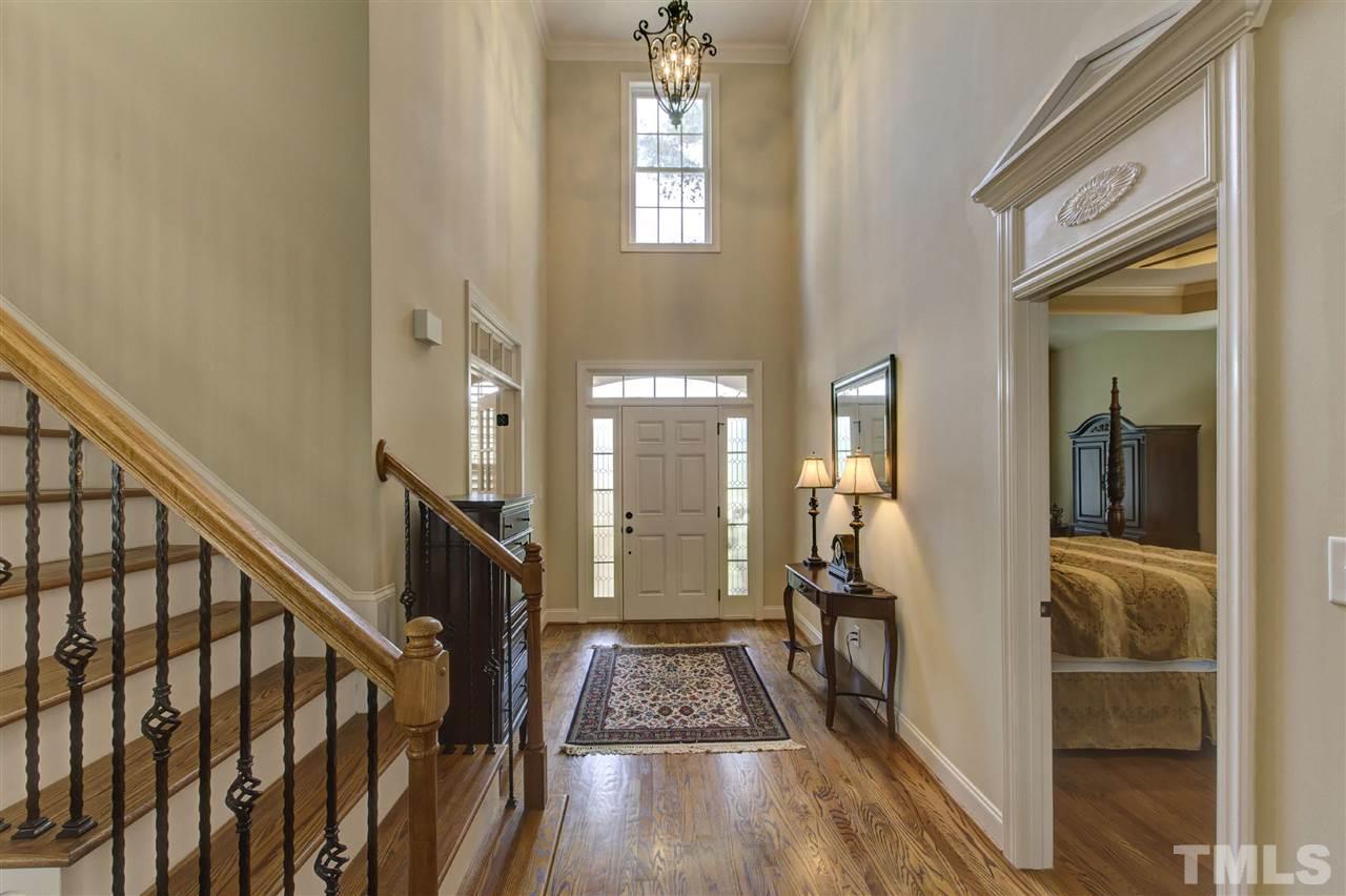 5804 Turner Store Lane Raleigh, NC 27603 - Photo 6 of 25 a view of hallway with wooden floor and stairs
