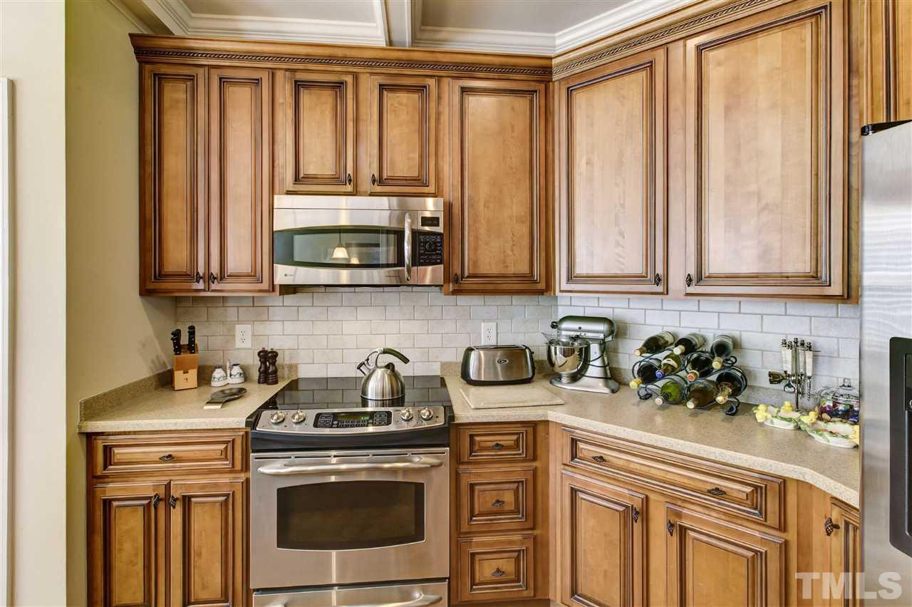5804 Turner Store Lane Raleigh, NC 27603 - Photo 9 of 25 a kitchen with stainless steel appliances a stove a microwave and cabinets