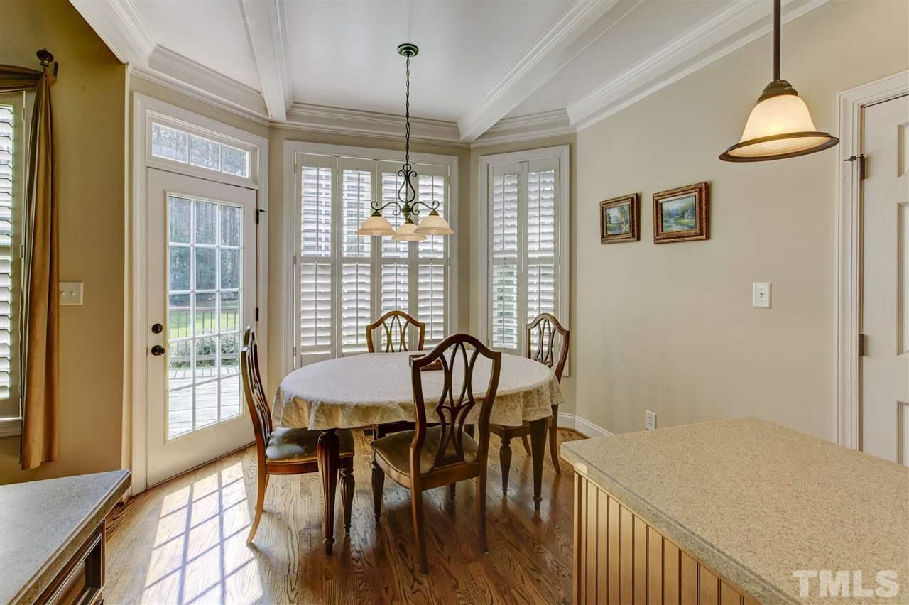 5804 Turner Store Lane Raleigh, NC 27603 - Photo 10 of 25 a view of a dining room with furniture window and wooden floor