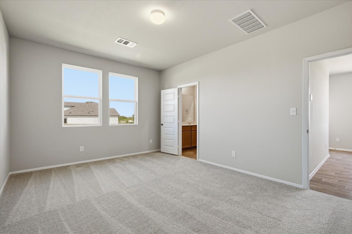 2714 Foss Road Manor, TX 78653 - Photo 17 of 34 Plush carpeting and dual windows define this comfortable secondary bedroom.