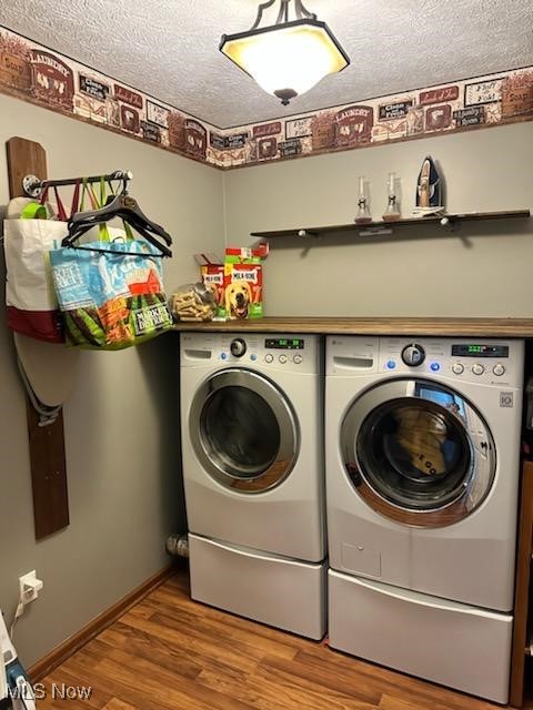 2761 Omega Road Greenwich, OH 44837 - Photo 14 of 50 Washroom with light hardwood / wood-style floors, a textured ceiling, and washing machine and clothes dryer