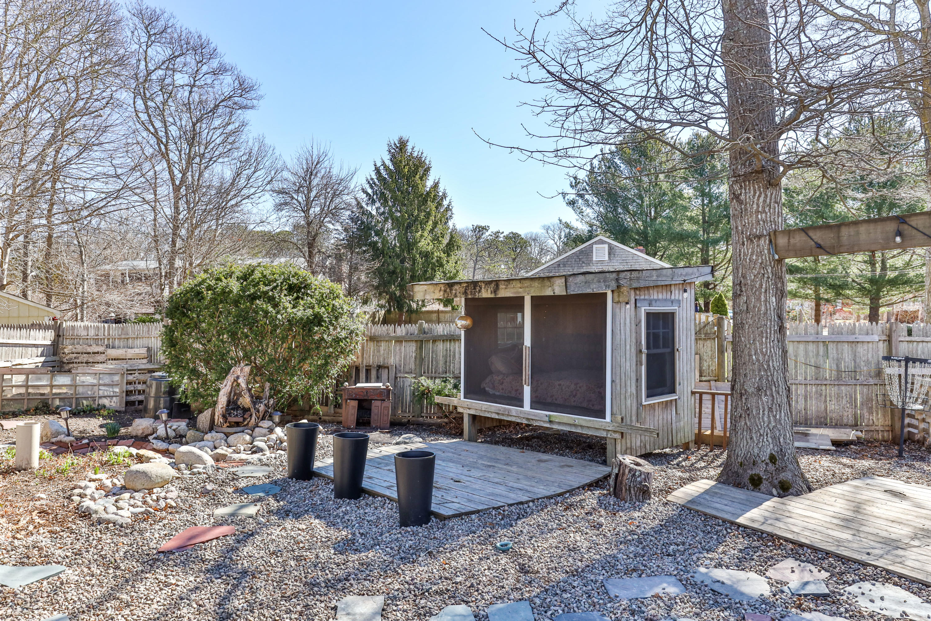 110 Kelley Road Hyannis, MA 02601 - Photo 44 of 49 a view of a patio with table and chairs under an umbrella