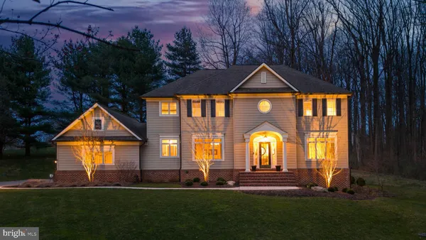 a front view of a house with a garden and plants