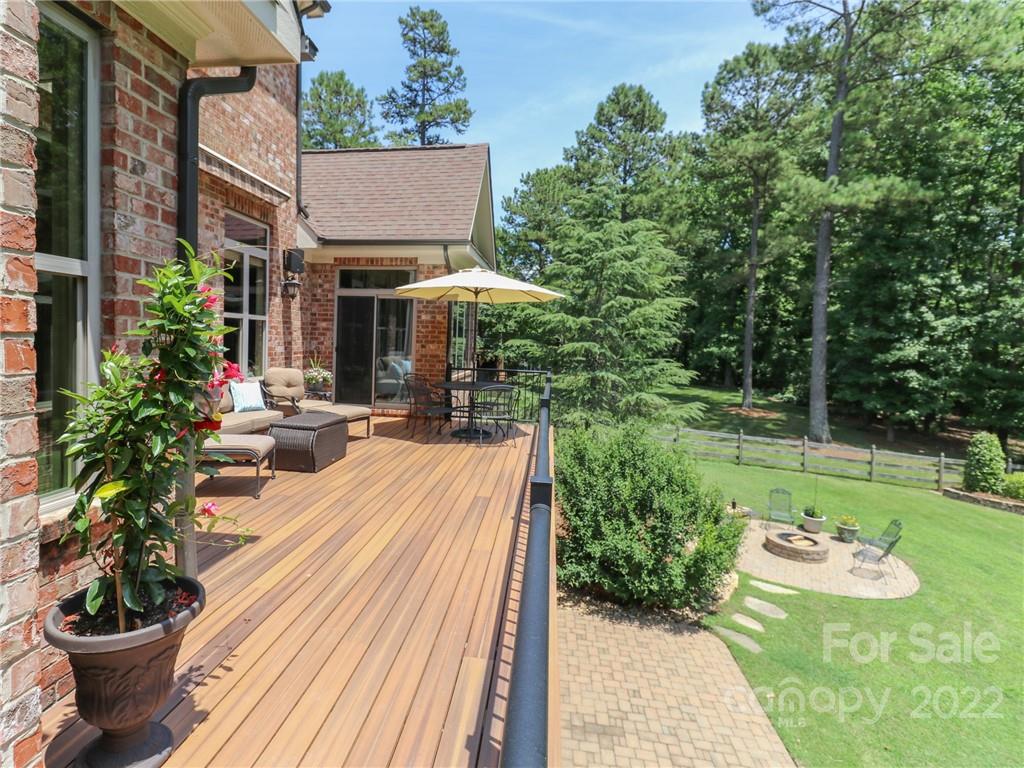 251 Old Post Road Weddington, NC 28173 - Photo 19 of 46 a view of backyard with table and chairs and potted plants