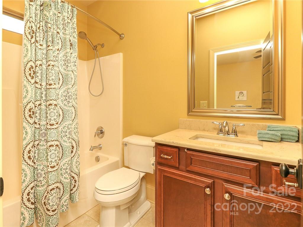 251 Old Post Road Weddington, NC 28173 - Photo 22 of 46 a bathroom with a granite countertop toilet sink and mirror