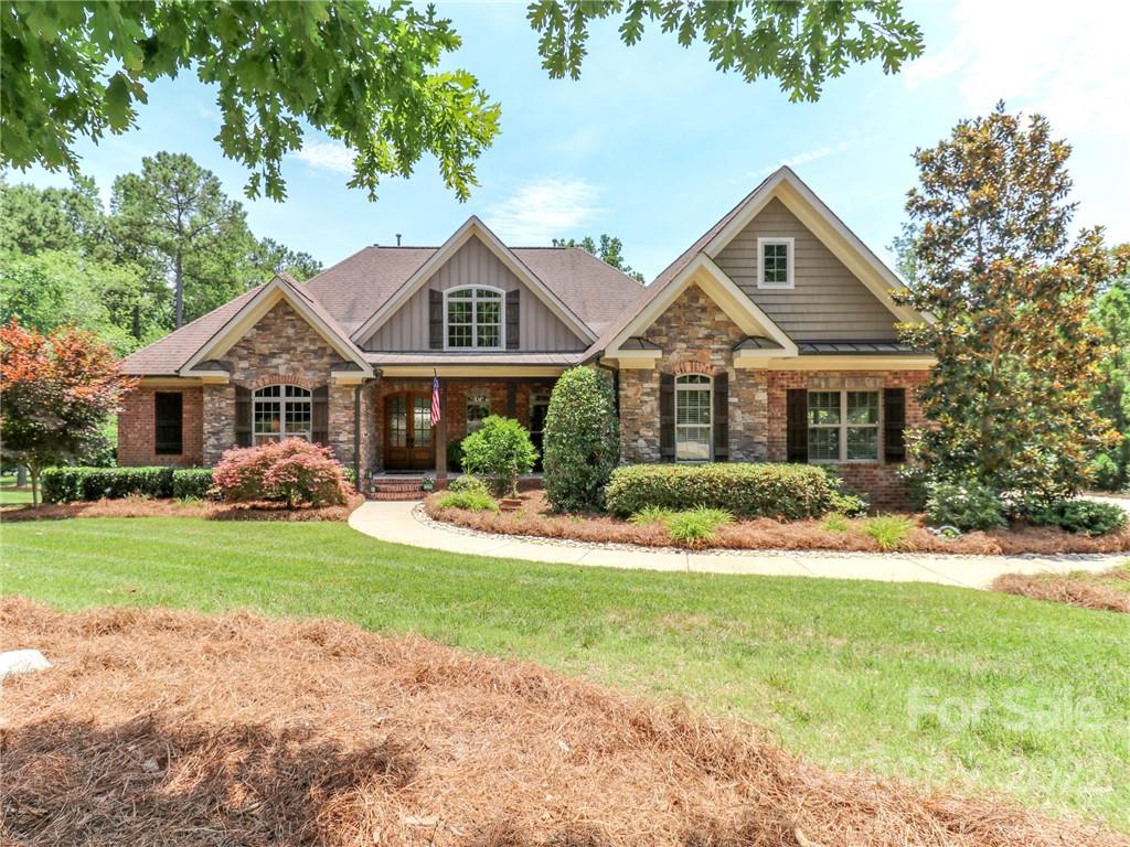 251 Old Post Road Weddington, NC 28173 - Photo 41 of 46 a front view of a house with a garden and trees
