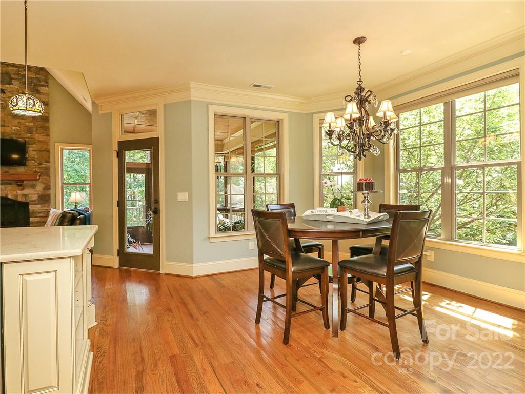 251 Old Post Road Weddington, NC 28173 - Photo 9 of 46 a view of a dining room with furniture wooden floor and chandelier