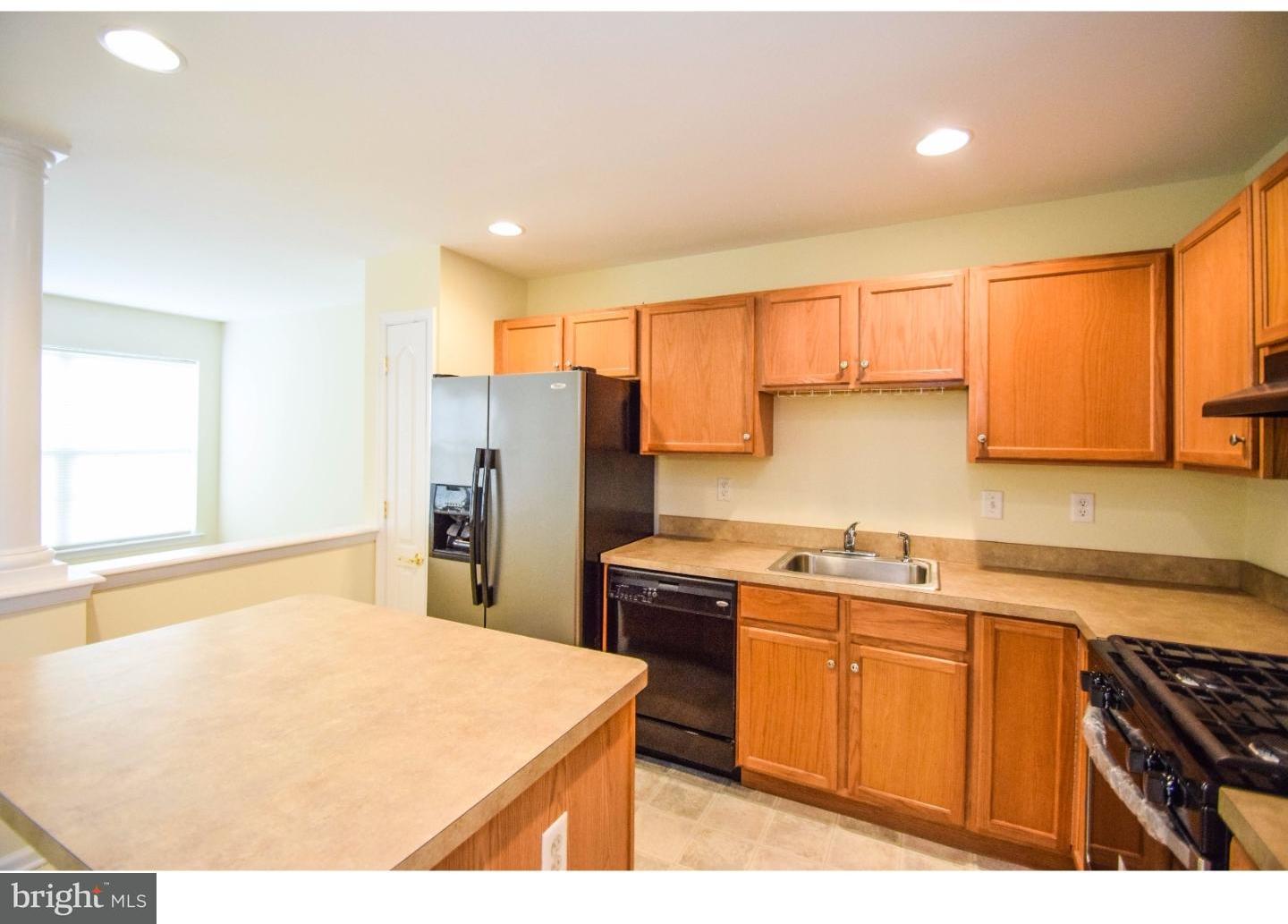 1025 Moore Road Thorofare, NJ 08086 - Photo 12 of 25 a kitchen with stainless steel appliances a sink a stove a refrigerator cabinets and a window