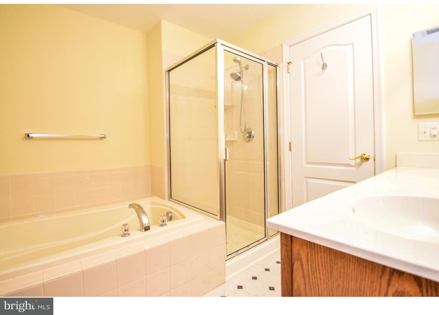 1025 Moore Road Thorofare, NJ 08086 - Photo 18 of 25 a bathroom with a bathtub and a shower