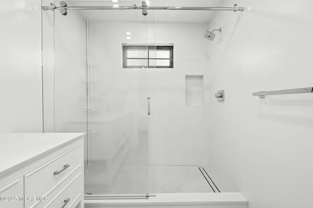 a bathroom with a shower and a sink