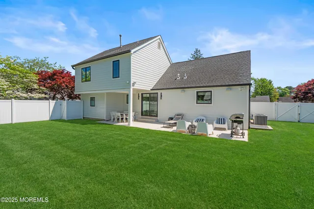 a front view of house with yard and outdoor seating