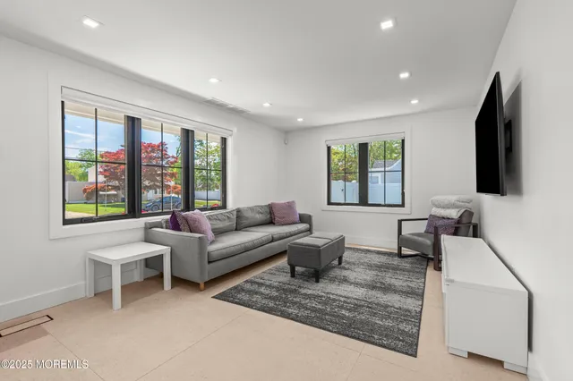 a living room with furniture tv and a flat screen tv