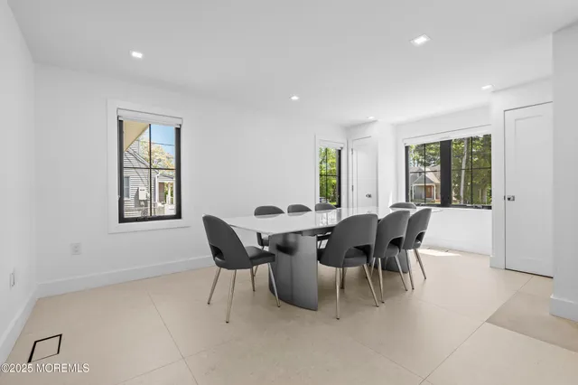 a view of a dining room with furniture and chandelier