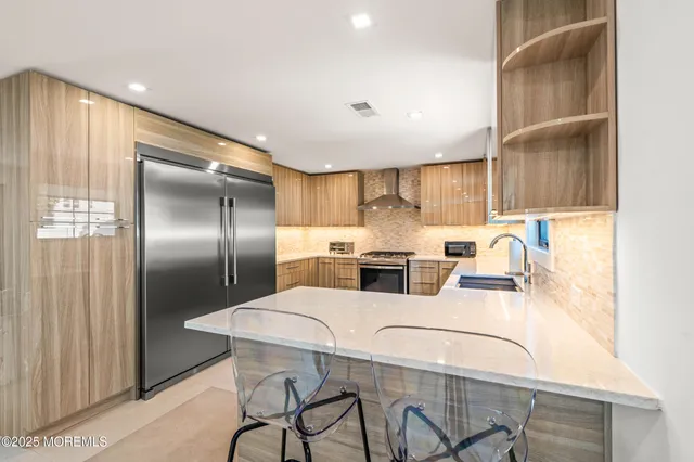 a kitchen with stainless steel appliances refrigerator and microwave