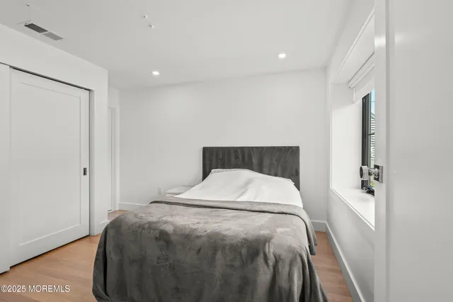 a bedroom with a bed and a night stand